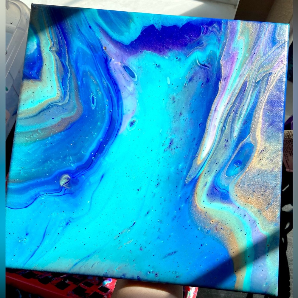 This is a 10x10 acrylic pour painting on stretched canvas.